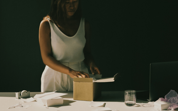 woman putting together product package