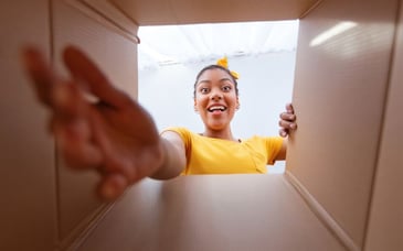 excited woman opening package 